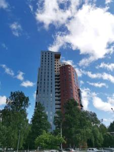 a tall building with trees in front of it at Solaris Studio Apartments in Rīga
