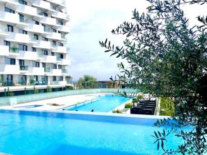 a large swimming pool next to a building at Veli Apartments 348 Infinity in Mamaia Sat/Năvodari