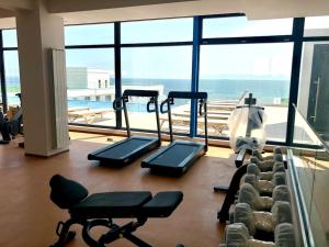 a gym with cardio equipment and a view of the ocean at Veli Apartments 348 Infinity in Mamaia Sat/Năvodari