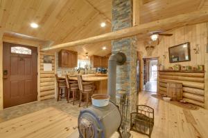 a large kitchen with a stove in a log cabin at Trout Ponds and Sauna Unique Log Cabin in Freedom in Freedom