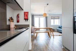 a kitchen with a table and a dining room at The Waves in Newquay