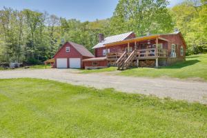 a large red house with a red barn at Trout Ponds and Sauna Unique Log Cabin in Freedom in Freedom