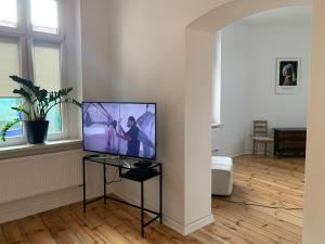 Na skraju Rynku 110 m2 في تارنوفسكي غوري: غرفة معيشة مع تلفزيون بشاشة مسطحة على منصة
