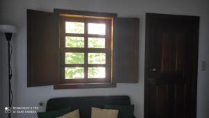 een raam boven een bank in een woonkamer bij Casa Azul em Chaves in Chaves