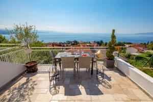 a patio with a table and chairs on a balcony at Apartment Mak in Opatija