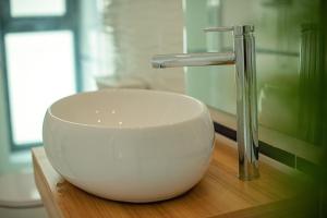 a sink and a faucet on a wooden table at Forest by the sea in Jupiter