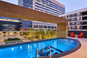 a swimming pool on the roof of a building at Aloft Richardson in Richardson