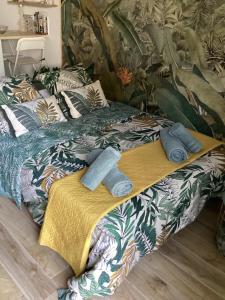 a bed with two pairs of towels on it at Guest house arboré in Saint-Loubès
