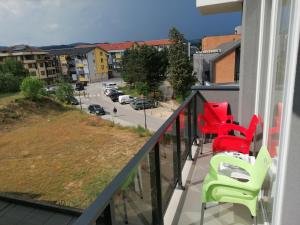 a balcony with chairs and a view of a street at Kristi Lux Jezero - NEW Studio apartment with Balcony and FREE Parking in Veliko Gradište