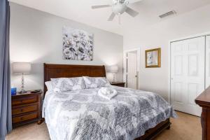 a bedroom with a bed and a ceiling fan at Disney Area Villa w/Pool Heat Included Featuring in Orlando