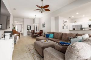 a living room with a couch and a dining room at Disney Area Villa w/Pool Heat Included Featuring in Orlando