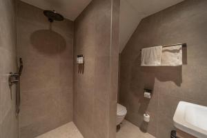 a bathroom with a toilet and a sink at Strandstudio's Camperduin in Schoorl