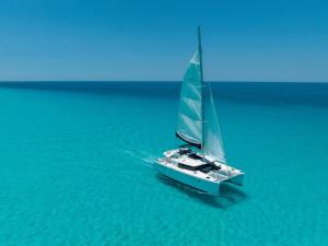 a sail boat floating in the water at Impression Isla Mujeres by Secrets - Adults Only - All Inclusive in Isla Mujeres