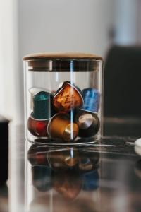 a glass container filled with different types of buttons at Queen Cattleya Suite in Genova