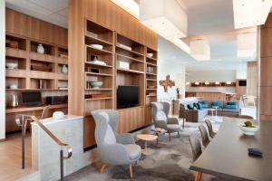 a living room with a table and chairs and a television at Element Dallas Love Field in Dallas