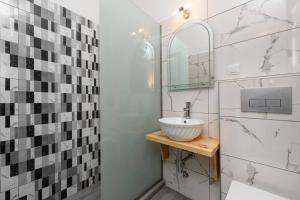 a bathroom with a sink and a mirror at Maria's House in Potamiá +10 photos