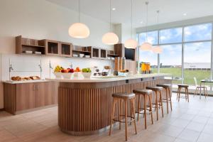 a kitchen with a counter with bar stools at Element Dallas Love Field in Dallas