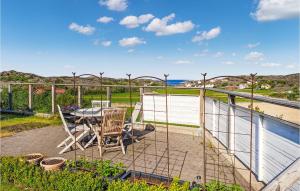 a patio with a table and chairs on a deck at Beautiful Apartment In Skrhamn With Wifi in Skärhamn