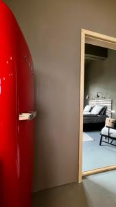 a red refrigerator in a room with a bedroom at Smiðjan - main road Stykkishólmi in Stykkishólmur