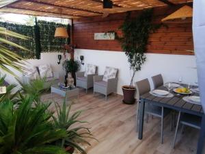 a patio with a table and chairs and plants at Casa Leti in Benitachell