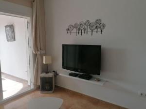a flat screen tv sitting on a white wall at Casa Leti in Benitachell