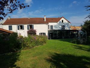 a large white house with a grass yard at La demeure de Liers in Sainte-Geneviève-des-Bois