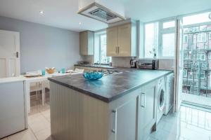 a large kitchen with a counter top and a sink at 4 Bedroom in Finchley Road in London