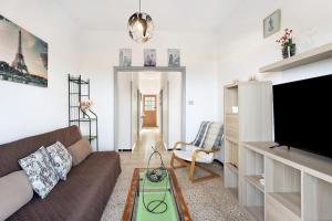 a living room with a couch and a flat screen tv at Punta del Sol Familiar in Tijarafe