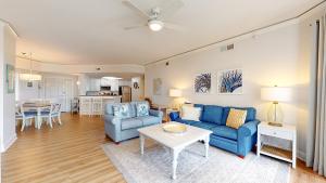 a living room with a blue couch and a table at 2113 Windsor Place II in Hilton Head Island