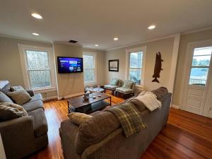 a living room with a couch and a tv at The Happy Place in Tilghman Island
