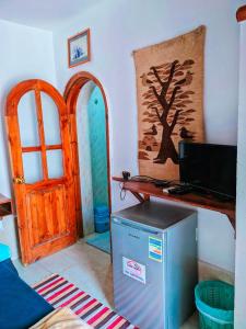 a room with a refrigerator and a door at Ghazala Boutique Hotel Dahab in Dahab