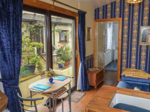 a living room with a table and a window at Turnpike Lodge in Paignton