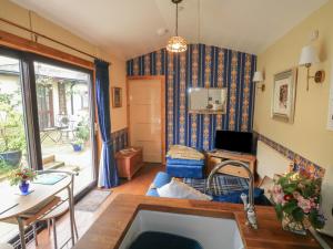 a living room with a couch and a table at Turnpike Lodge in Paignton