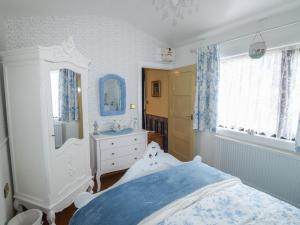 a bedroom with a bed and a sink and a mirror at Turnpike Lodge in Paignton