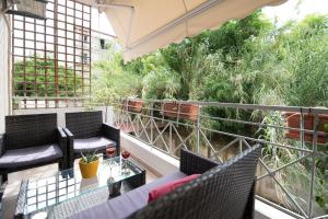 an outdoor balcony with chairs and a table at Charming Appt in Preveza