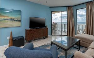 a living room with a tv and a couch and a table at Phoenix 5 Unit 1504 in Orange Beach