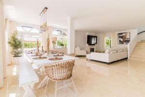 a living room with a white table and chairs at ARCADIA - AVENIDA 28 De LAS ADELFAS 29680 ESTEPONA, MALAGA in Estepona