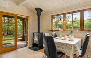 a dining room with a table and a wood stove at Two-Bedroom Holiday Home In Herning in Herning