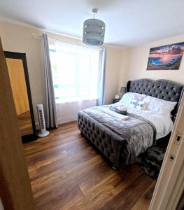 a bedroom with a large bed with a large window at Keniji Luxury 2 Bed Apartment in Milton Keynes