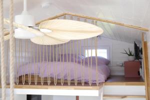 a bedroom with a bed with a wooden crib at Tiny House Gänseblümchen in Kirchanschöring