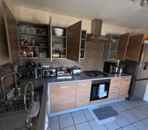 a kitchen with a sink and a stove top oven at Keniji Luxury 2 Bed Apartment in Milton Keynes
