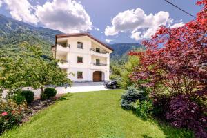 an exterior view of a house with a yard at Villa Santa Maria in Lovero Valtellino