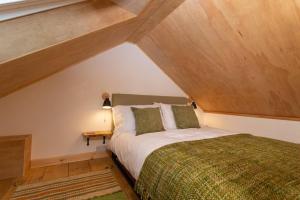 a bedroom with a bed in a attic at The Dairy in Tavistock
