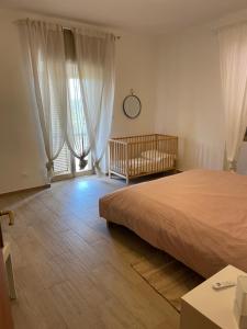 a bedroom with a bed and a crib in it at La casa di Michela in Torino di Sangro