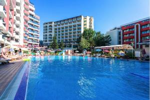 a large swimming pool in a city with buildings at Admiral Plaza in Sunny Beach