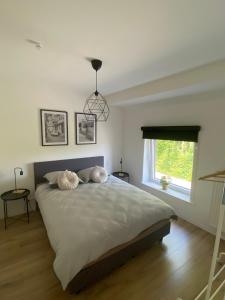 a bedroom with a large bed with two pillows on it at Maison Beau in Veurne