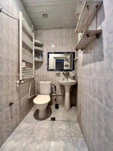 a bathroom with a toilet and a sink at LA CASA in Tbilisi City
