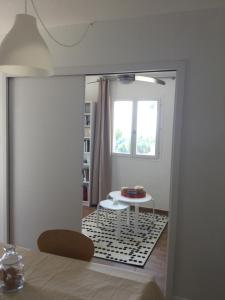 a dining room with a table and a window at La vigie in Cavalaire-sur-Mer