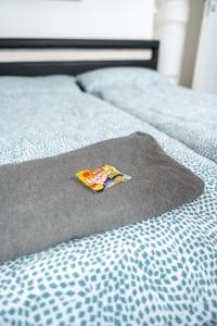 a close up of a bed with a pillow on it at #1 modernes Zimmer mit Pool und Garten in Memmingen