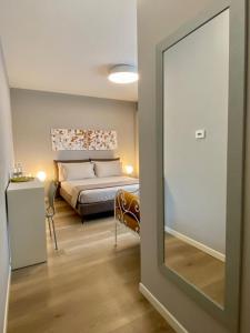 a bedroom with a bed and a mirror at Casa Clerici 1956 in Erbusco